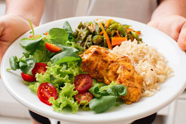 Prato de frango grelhado, arroz integral, legumes e salada fresca